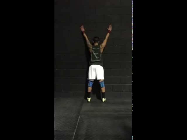 Overhead scapular elevation and depression with wall slide assist